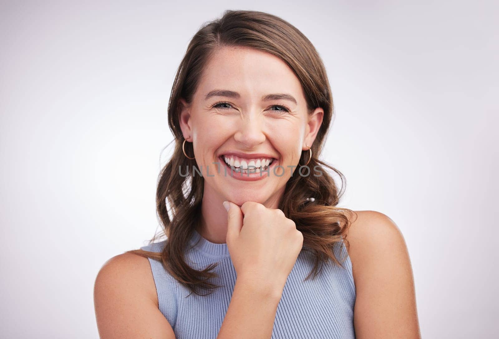 Laughing, woman and portrait in white studio background for skincare, glow and cosmetics or confidence. Happy, female person and smile or joyful for dermatology results, treatment and wellness.