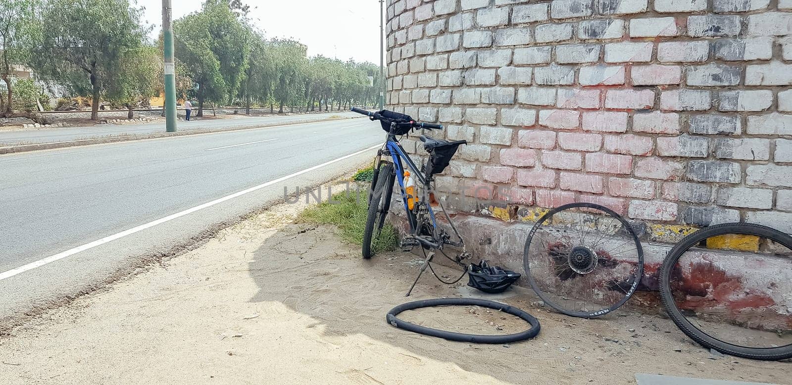 Bicycle repair in the middle of the road, rim chamber with hole