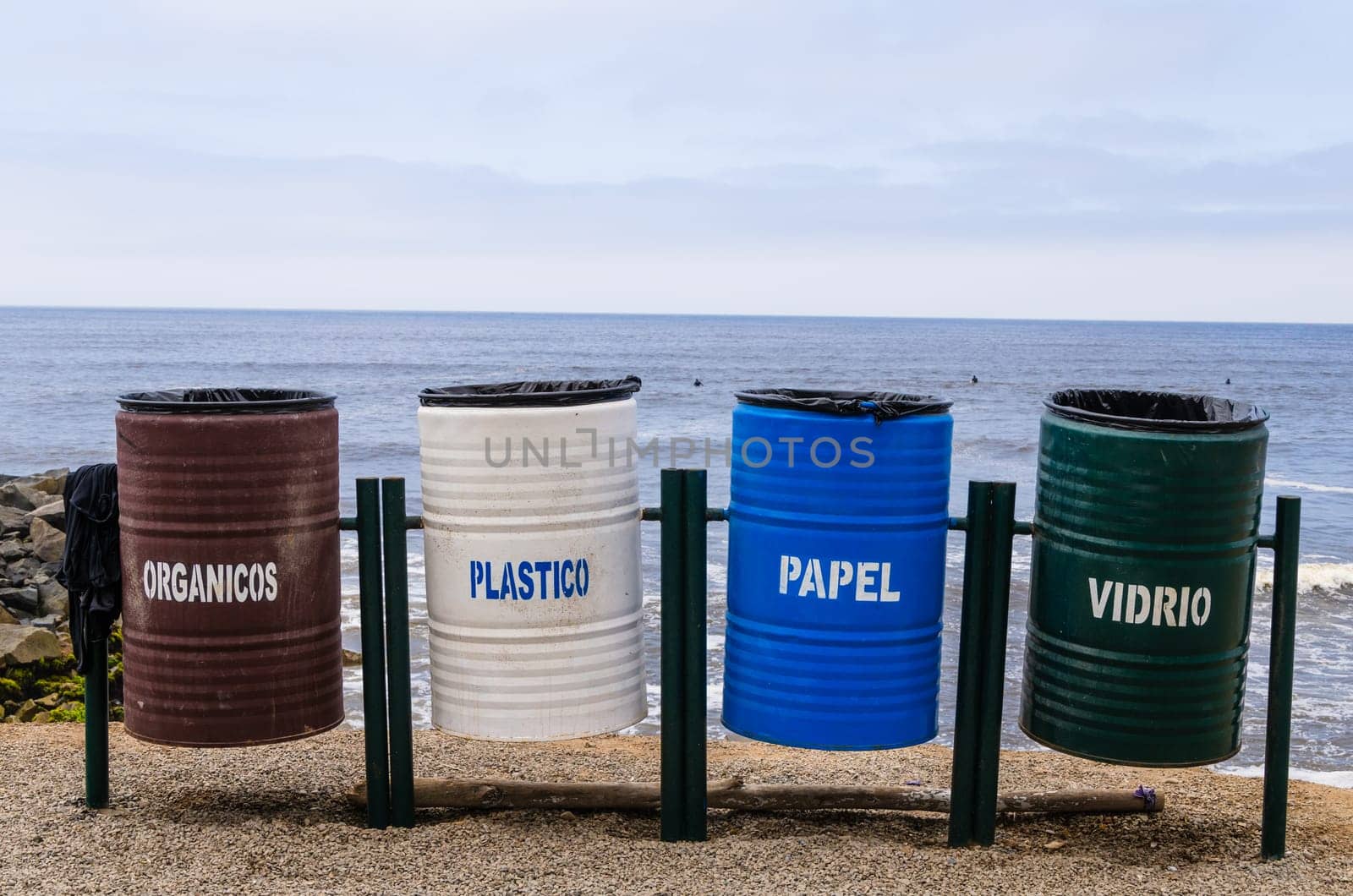 Colorful recycling bins for collecting recycled materials on the beaches of the Lima coast in Peru. by Peruphotoart