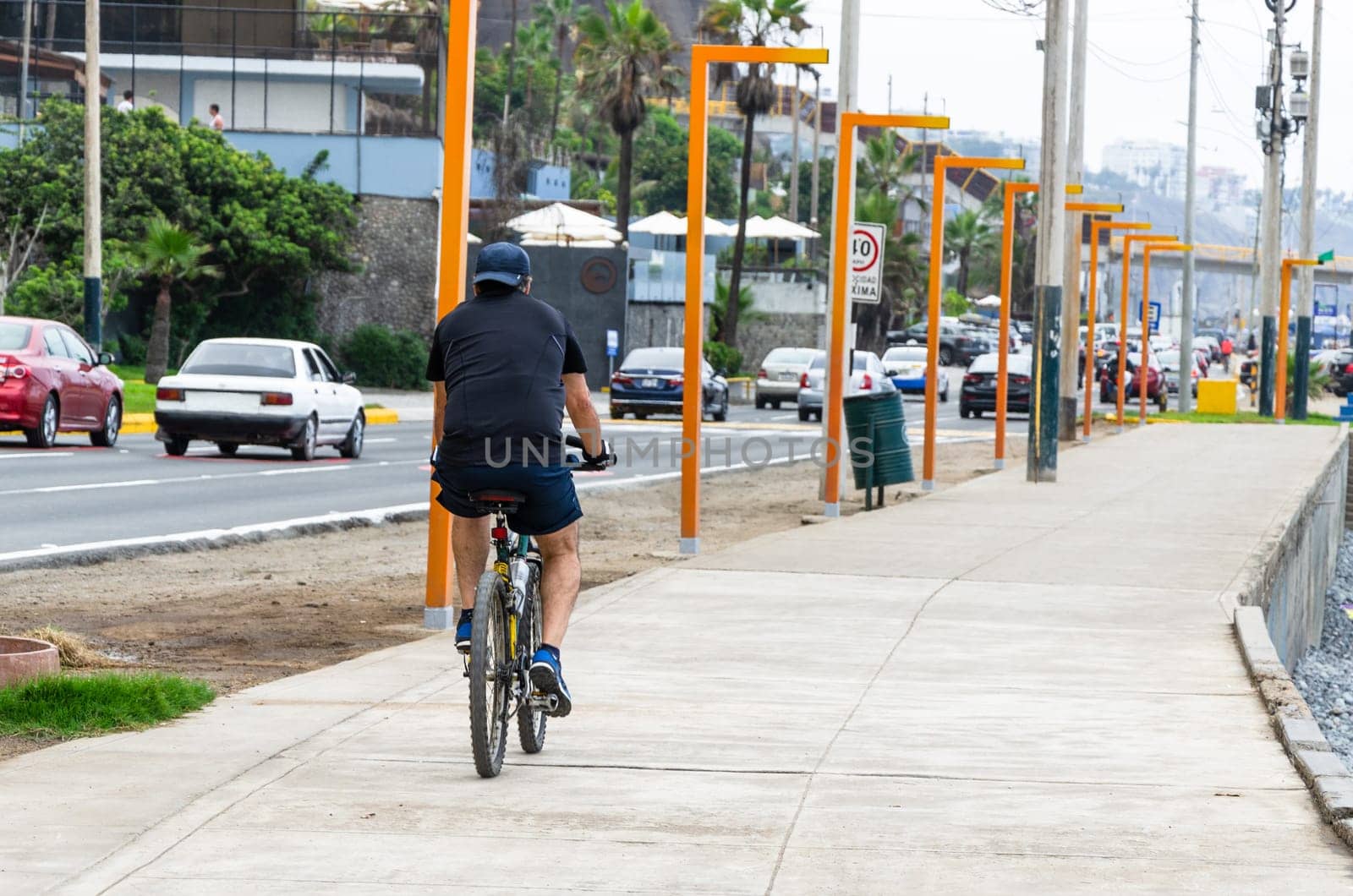 A cyclist riding his bike on the sidewalk, concept of sport life, healthy life