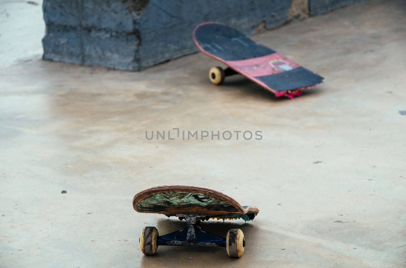 Broken skateboard on the asphalt street. Extreme sport, accident. by Peruphotoart