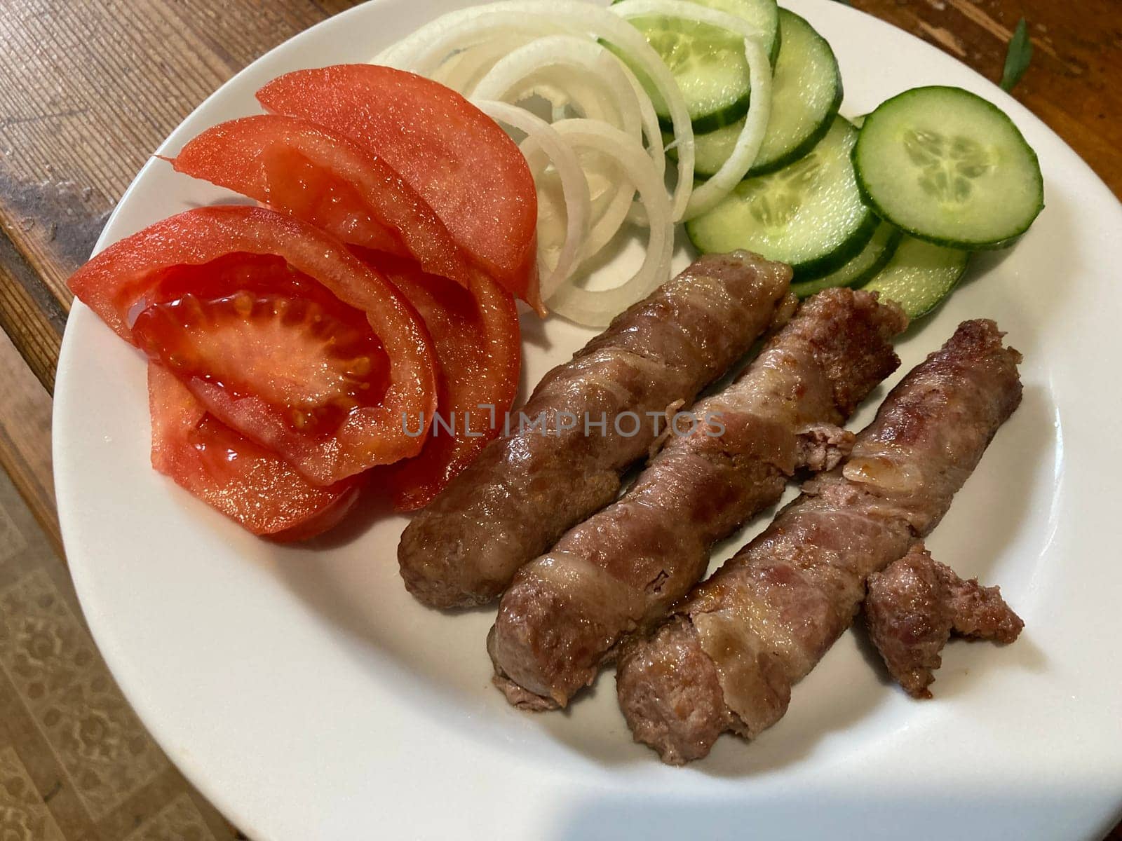 Cooking cevapchichi the Balkan meat sausages