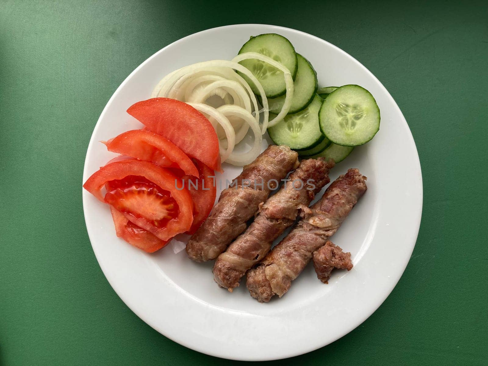 Cooking cevapchichi the Balkan meat sausages