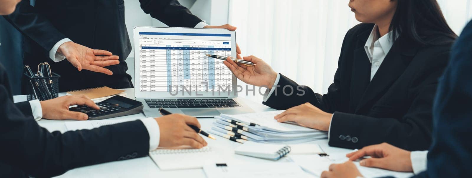 Corporate accountant team use accounting software on laptop to calculate and maximize tax refund and improve financial performance base on financial data. Modern business accounting . Shrewd