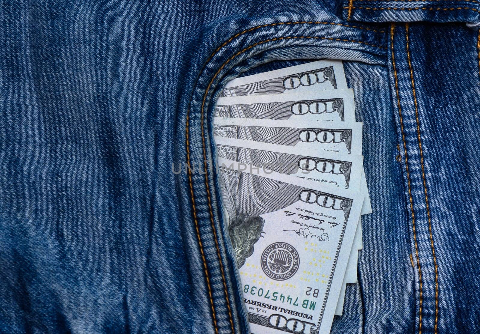 dollars bills lies in jeans pocket.money in wallet.savings.cash.international currency.