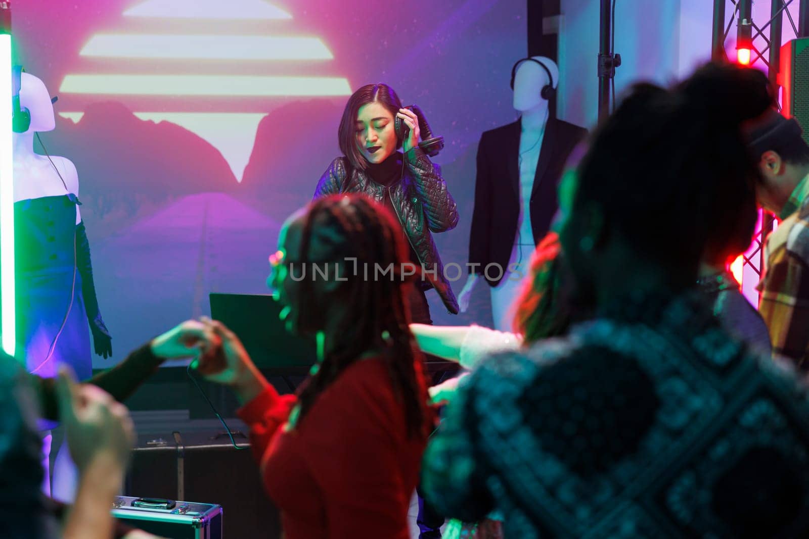 Woman dj performing on stage in club by DCStudio