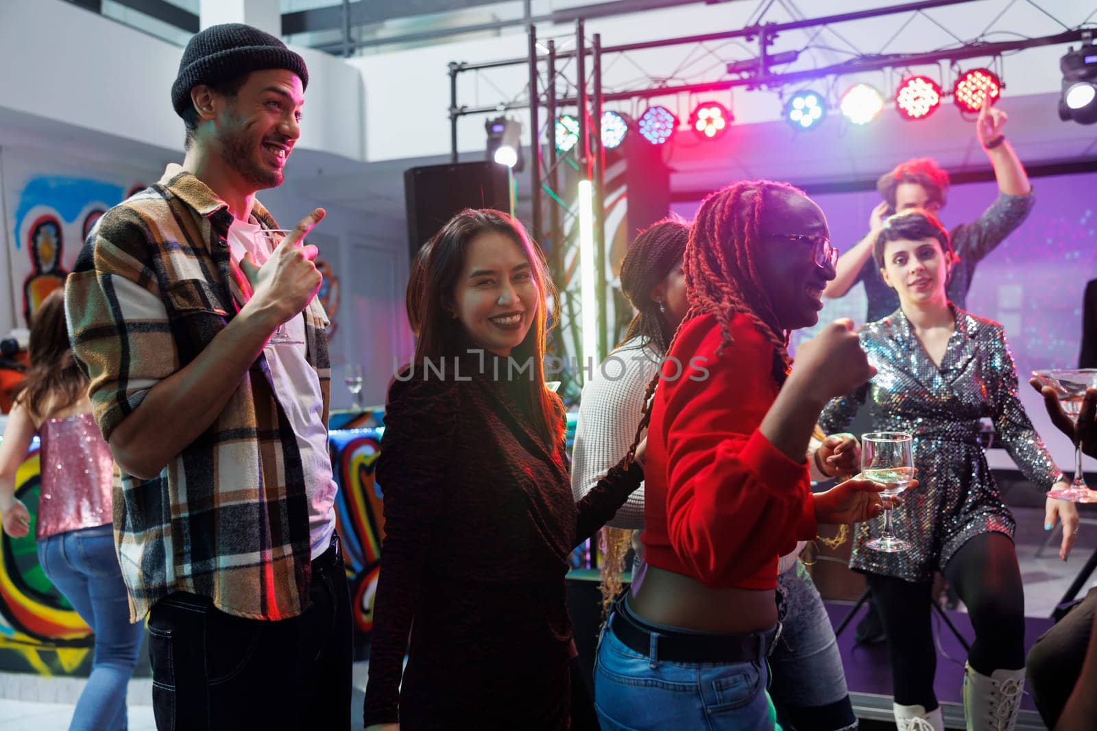 Smiling people drinking alcohol in club by DCStudio