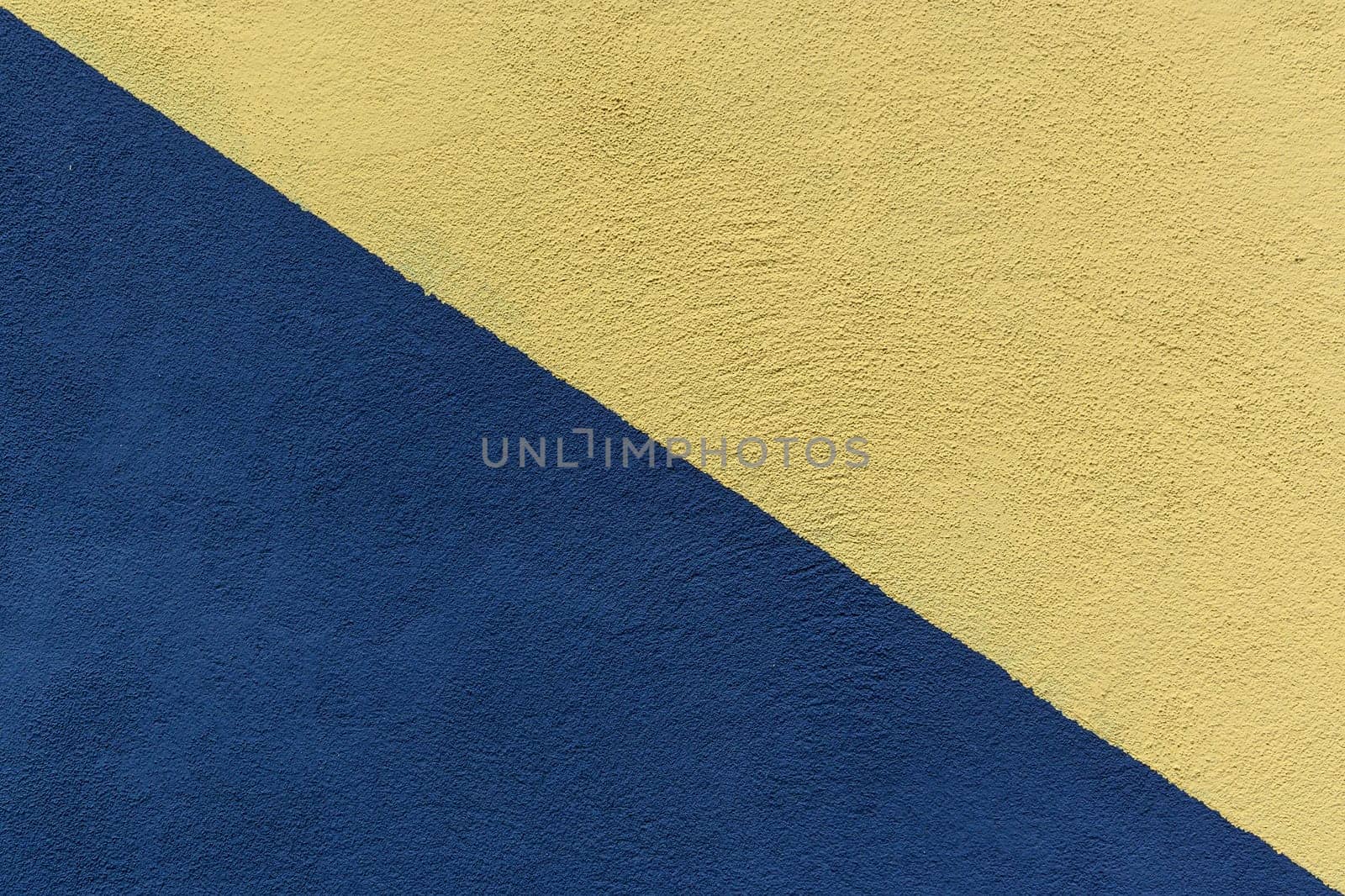 Colored paper in blue and yellow, divided in half, diagonally background