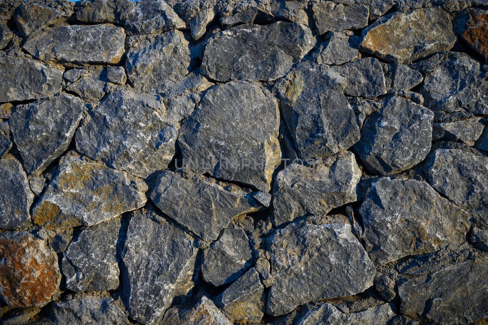 Old weathered stone wall of medieval fortress brick horizontal grunge background 1