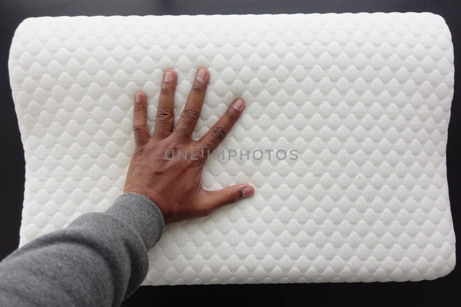 man hand on Orthopedic pillow on a bed by towfiq007