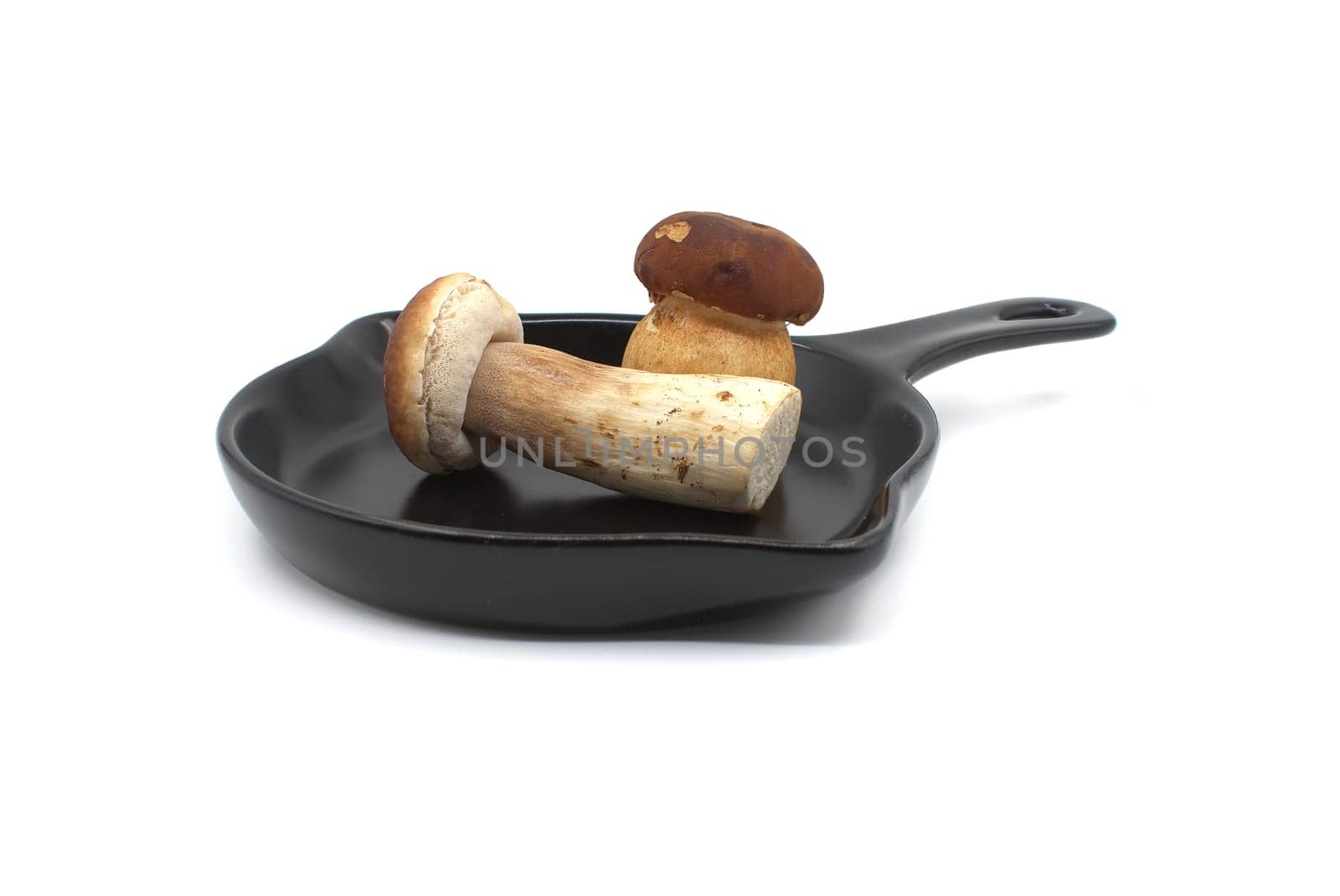 Culinary scene with mushrooms in fry pan by NetPix