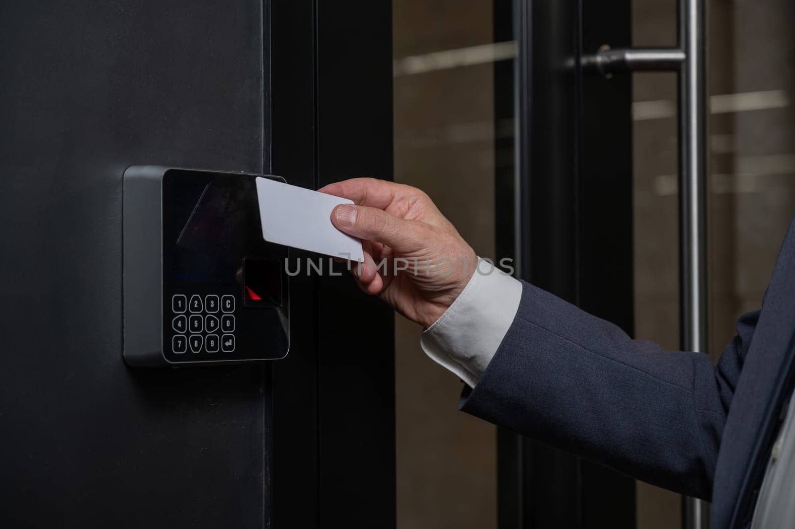 A man opens the door with a card. Modern electronic lock. Keyless Entry.