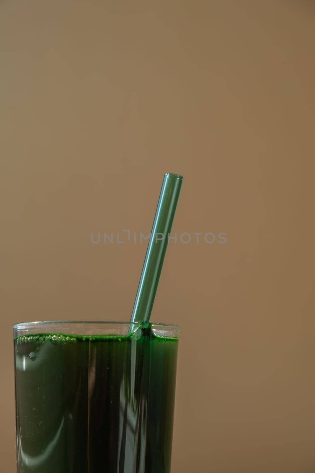 Natural organic green spirulina algae powder drink on neutral beige background. Chlorella seaweed vegan superfood cocktails smoothie supplement source and detox drinking. Innovative ingredient functional environmentally friendly food. Copy space Healthy nutritional antioxidant concept.