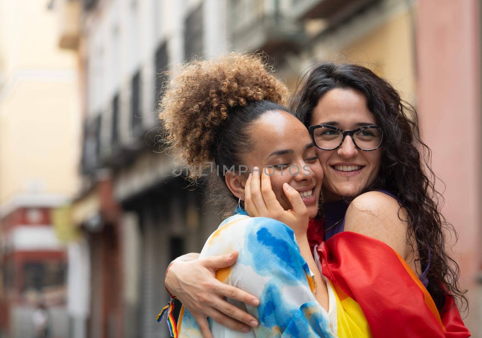 two loving lesbian women walking down the street in Madrid city with copy space.