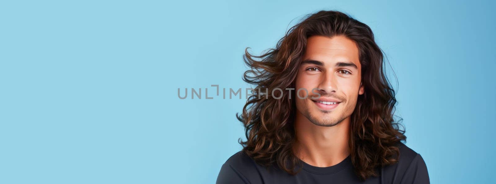 Portrait of an elegant sexy smiling Latino man with perfect skin and long hair, on a light blue background. by Alla_Yurtayeva
