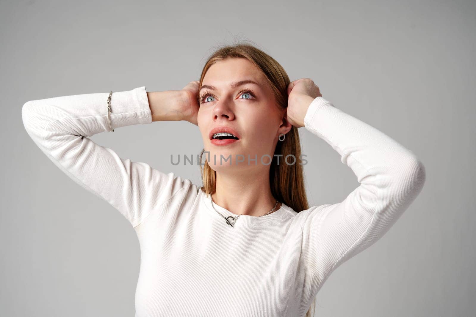 Young Woman Posing for Picture on gray background in studio