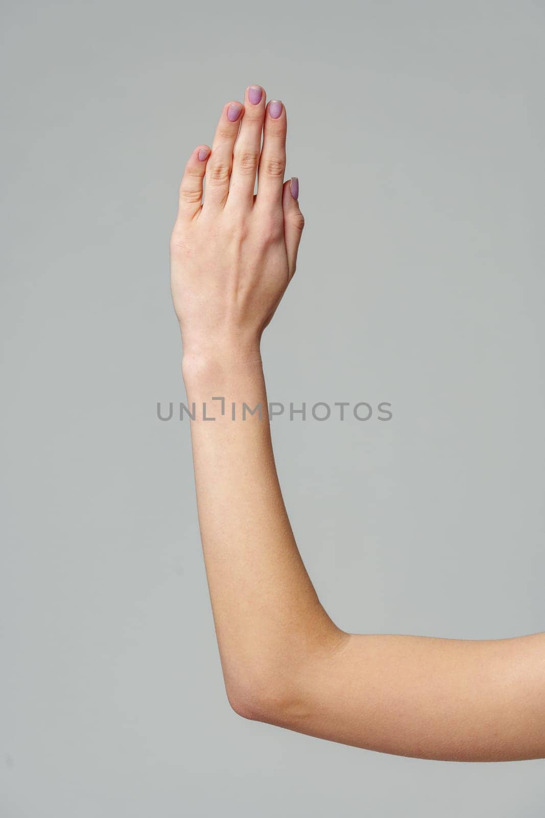 Open palm of a female hand o gray background close up