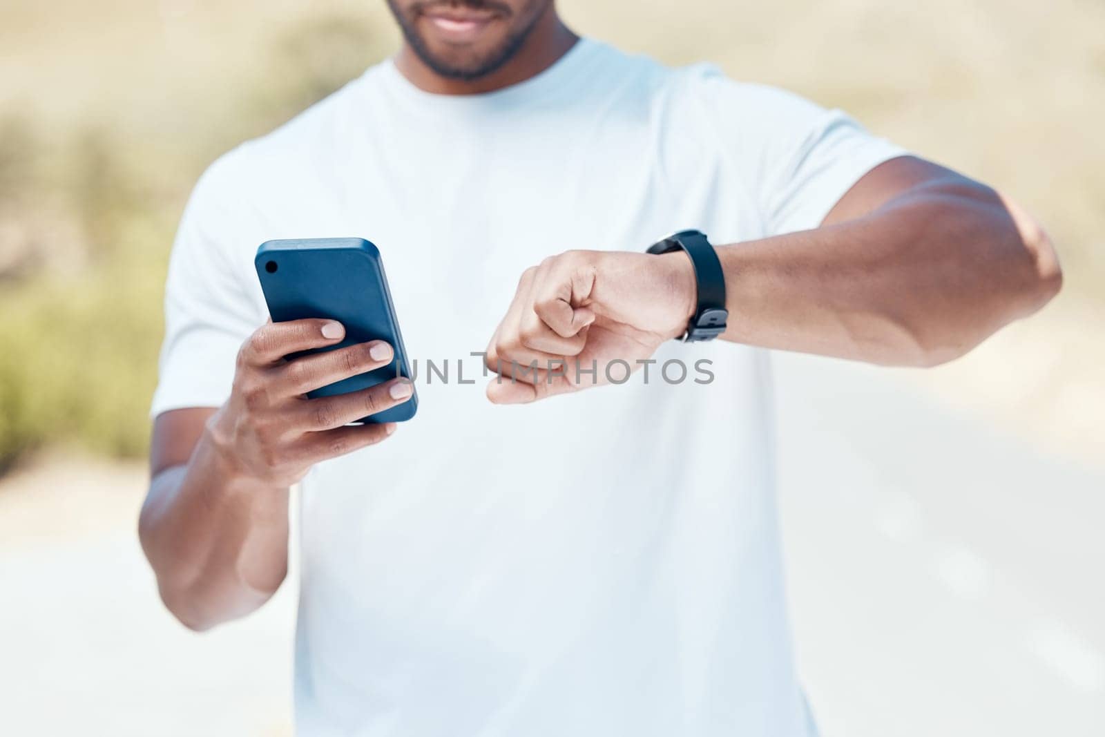 Man, hands and time with phone or fitness watch in nature for tracking performance or workout schedule. Closeup of male person, runner or athlete checking wristwatch for monitoring outdoor exercise.