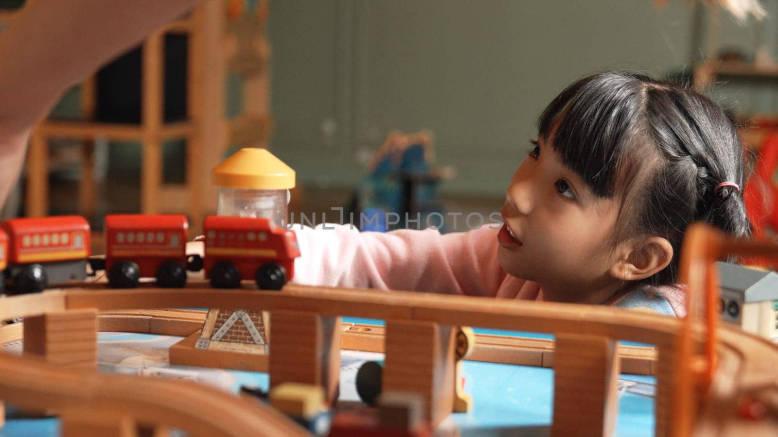 Closeup of cute asian girl playing car toy with friend at play room. Erudition. by biancoblue