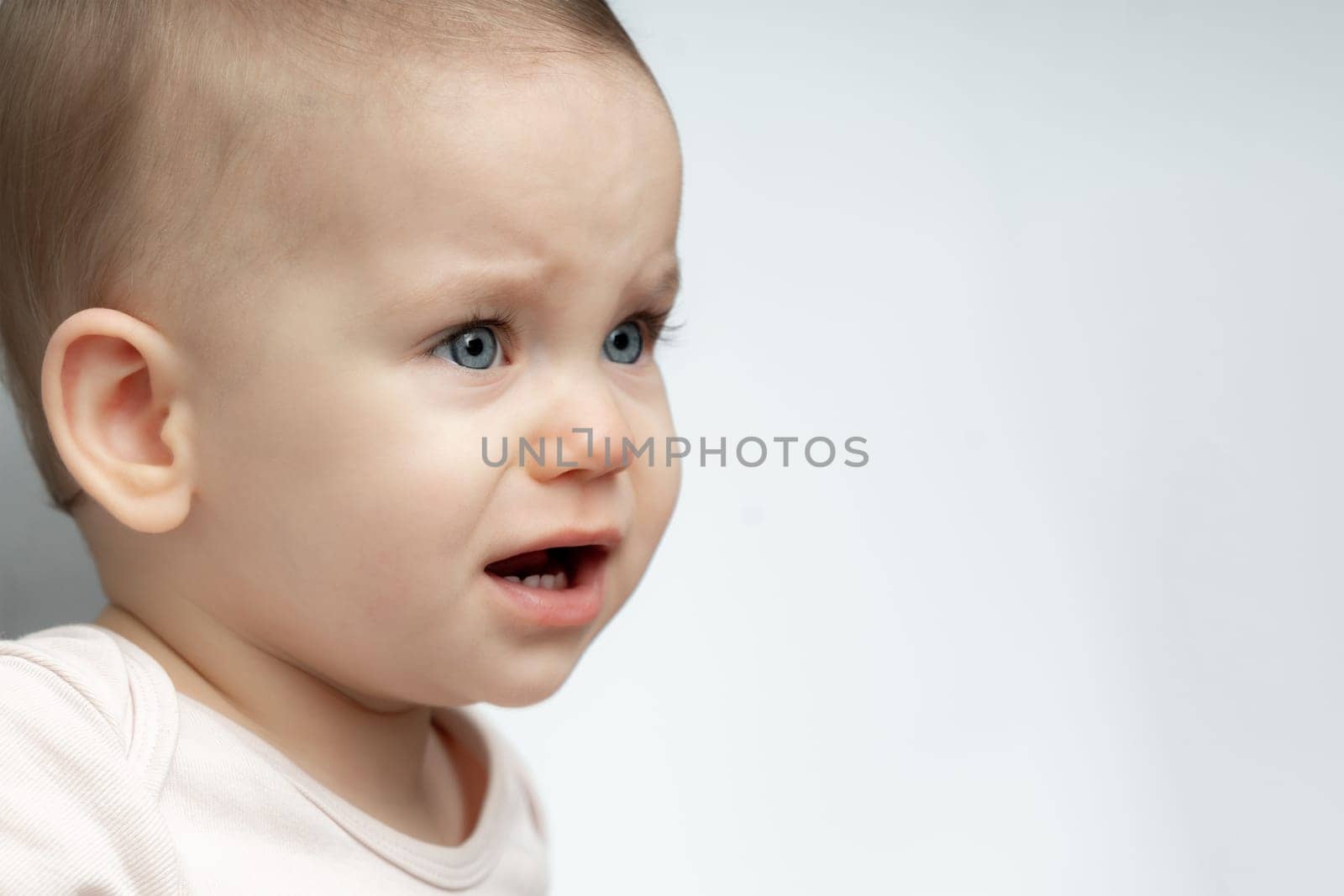 Portrait of sad and upset toddler baby because of being hungry and tired by Mariakray