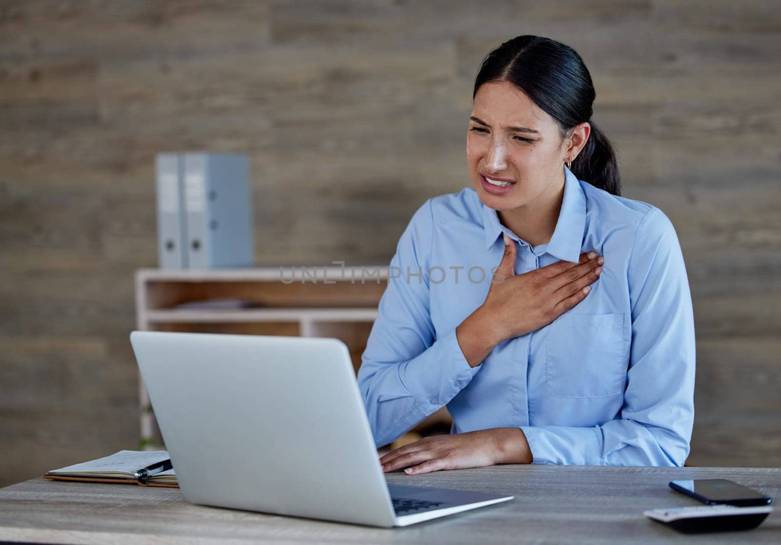 Stress, laptop and woman in office with chest pain from bad news, email or negative business review or feedback. Computer, anxiety or accountant with heartburn disaster from tax, audit or bankruptcy.
