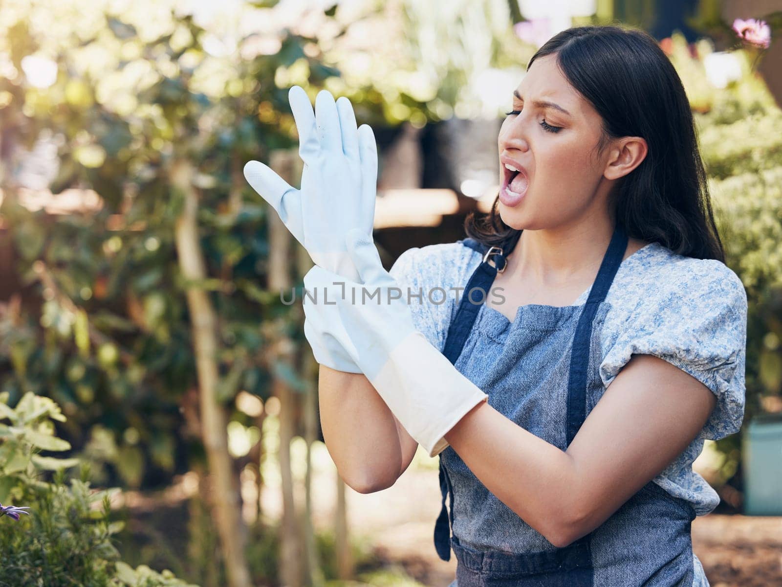 Woman, garden and hands at work in pain with wrist, green entrepreneur or landscaping. Female gardener, gloves and injury with problem for career with plants, startup with nature for sustainability by YuriArcurs