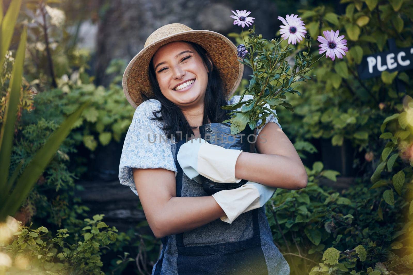 Smile, plant and portrait of woman in outdoor garden for environment, sustainability or ecology. Nature, happiness and person hug flowers for green nursery, agriculture or landscaping in backyard by YuriArcurs