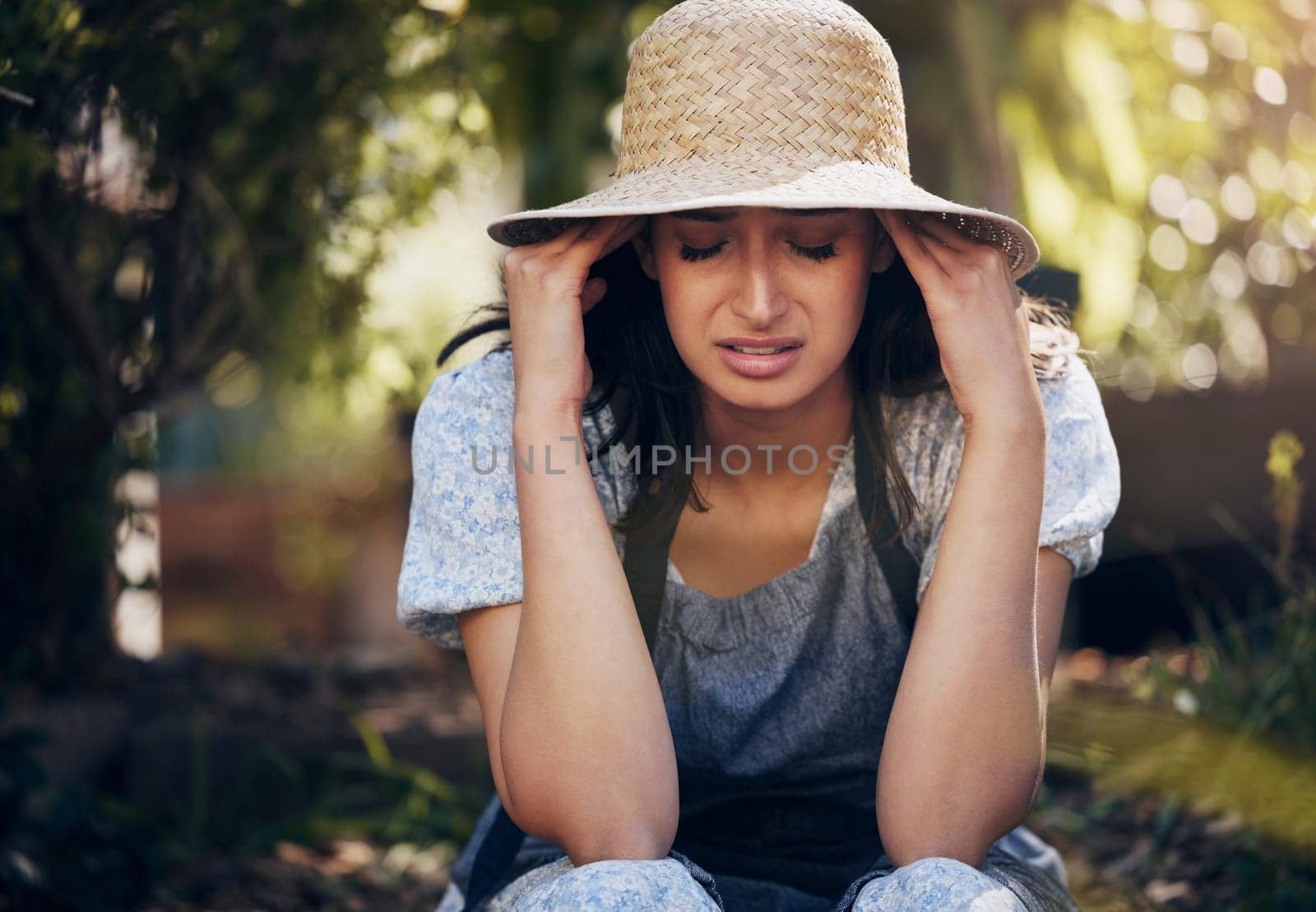 Woman, stress and garden with crying from sad news, depression and memories in home. Female person, outdoor and tears with emotional, frustration and sorrow from heartbreak or upset and disappointed.
