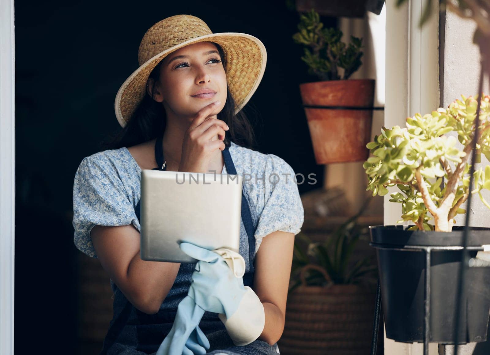 Girl, florist and thinking with tablet in garden to order supplies, inventory management and market research for business. Female gardener, digital tech and thoughts or ideas for nursery planning