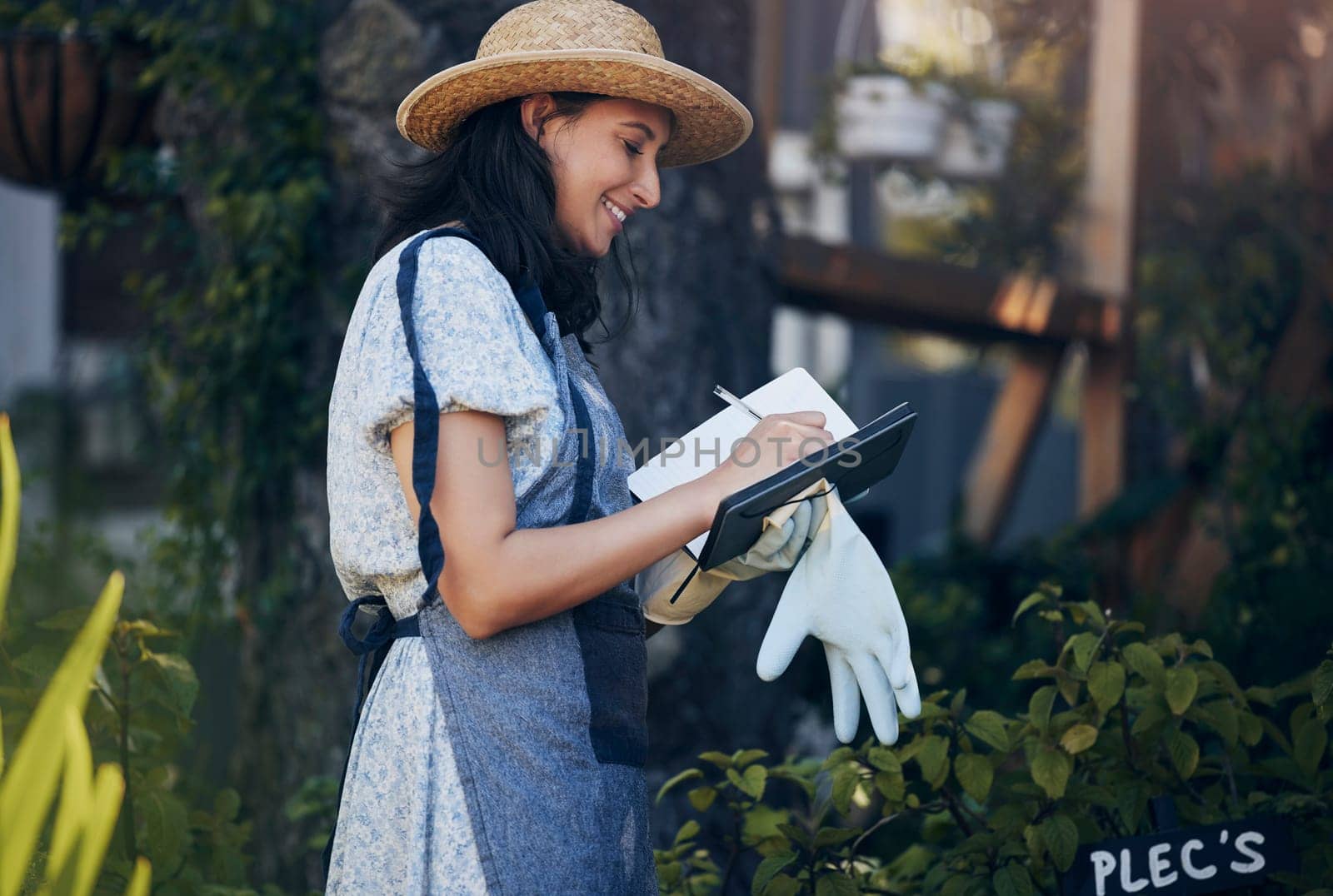 Writing, notebook and woman gardening in nature for growth inspection, development and nursery. Business, gardener and eco friendly farming checklist for plants, horticulture or floral sustainability.