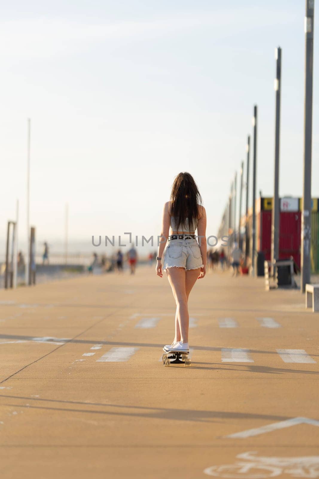 A woman is skateboarding down a sidewalk by Studia72