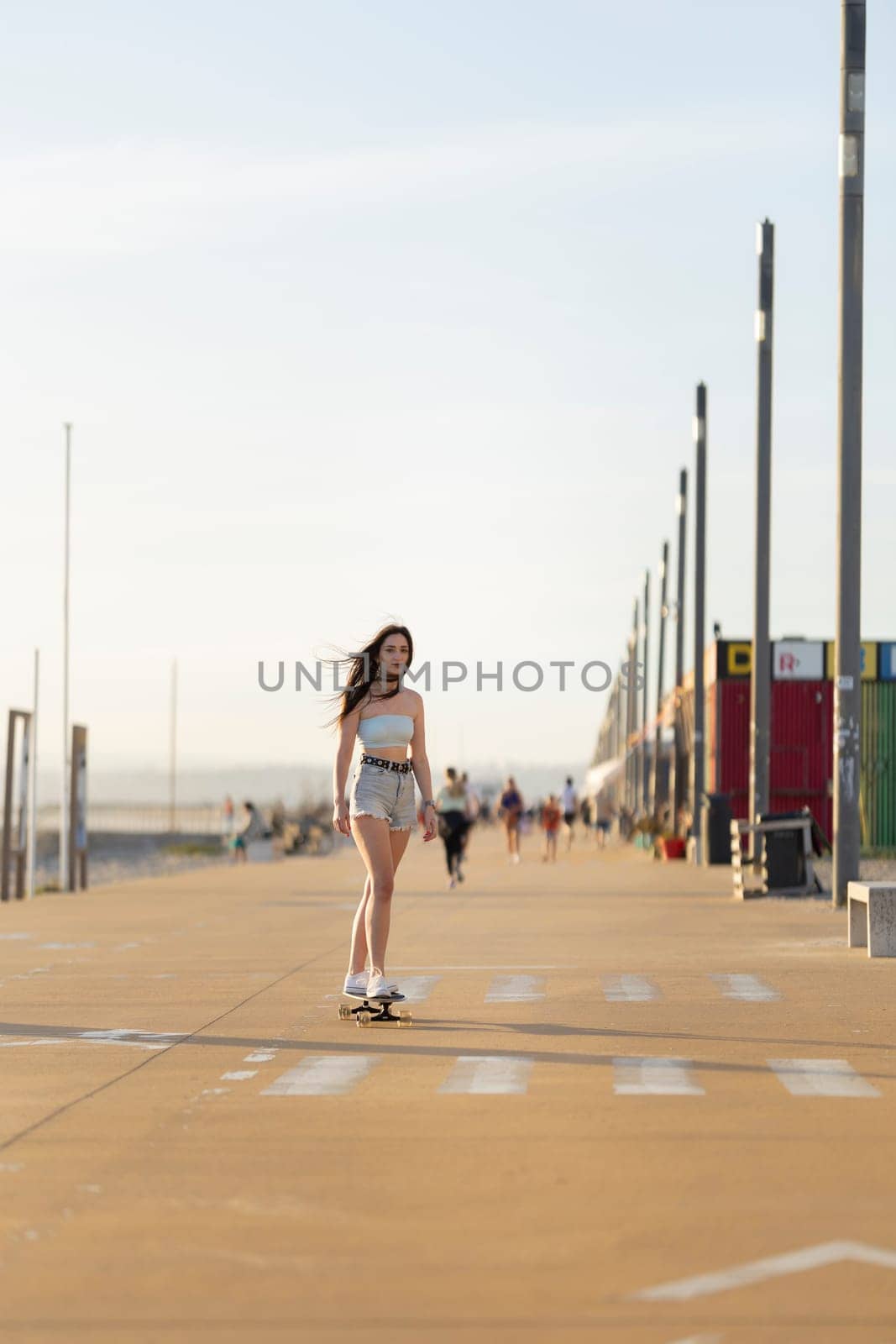 A woman is skateboarding down a sidewalk by Studia72