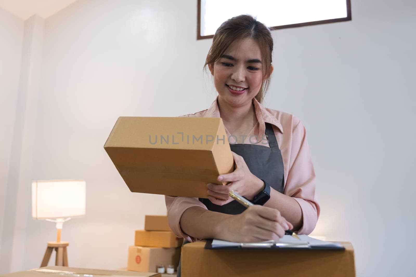 Startup small business entrepreneur SME, asian woman receive order on phone. Success young Asian small business owner home office, online sell marketing delivery by wichayada
