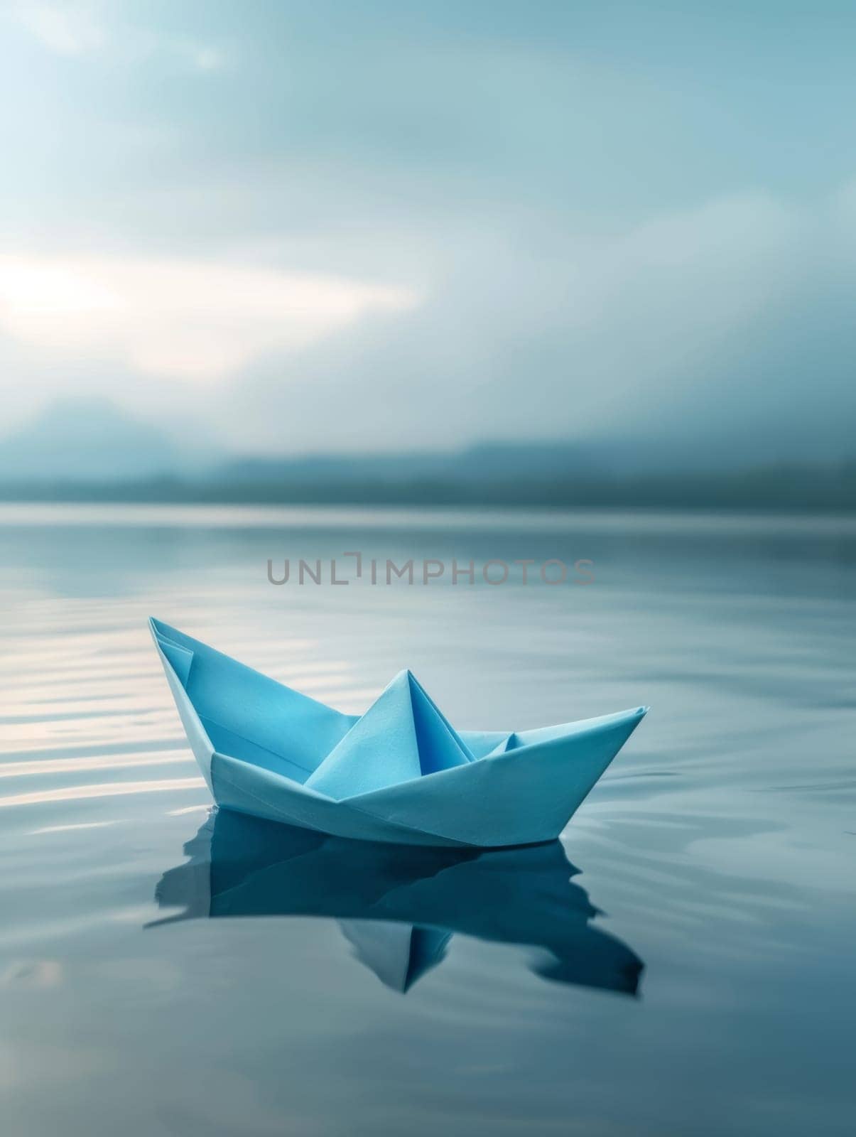 A blue origami boat rests on a glassy lake, its reflection a perfect symmetry in the waters calm