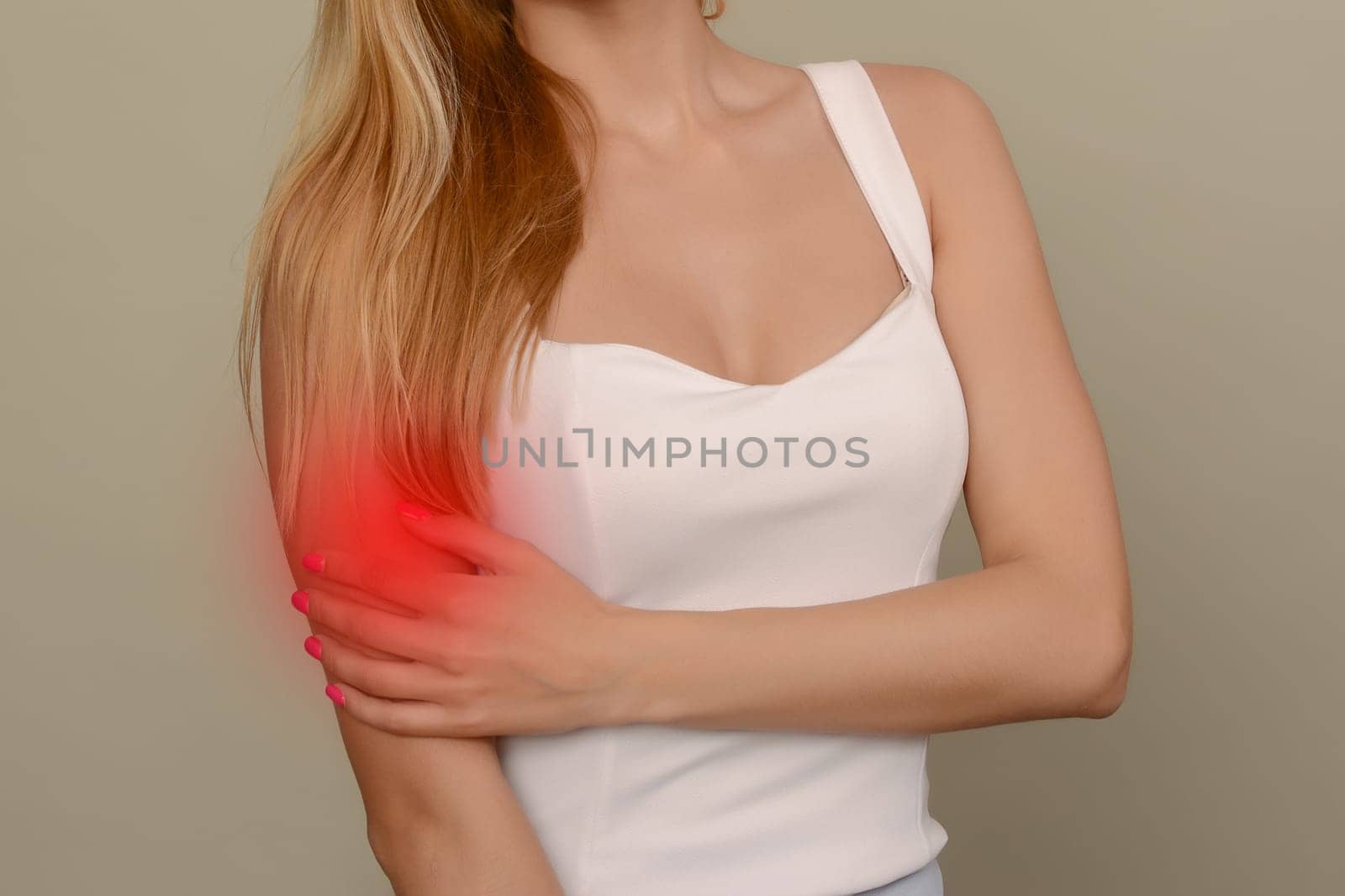 young woman experiencing pain in elbow joint