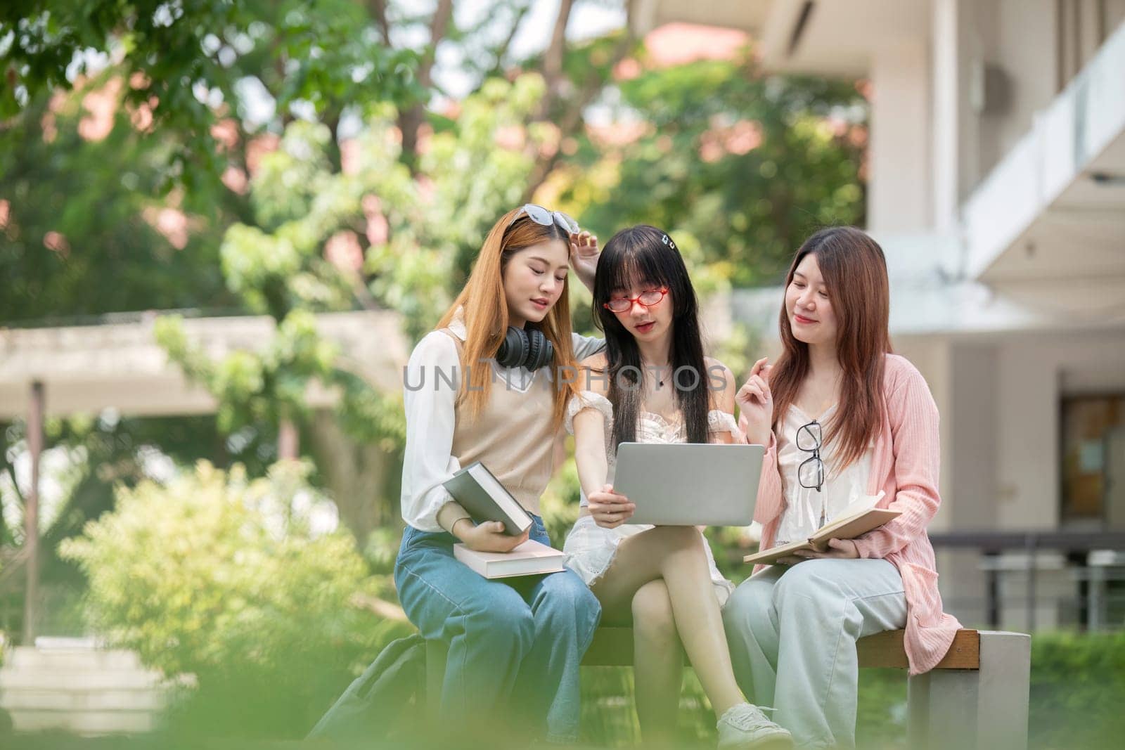 Asian young campus student enjoy learn study and reading books together. Friendship and Education concept. Campus school and university. Happiness and funny of learning in college by nateemee