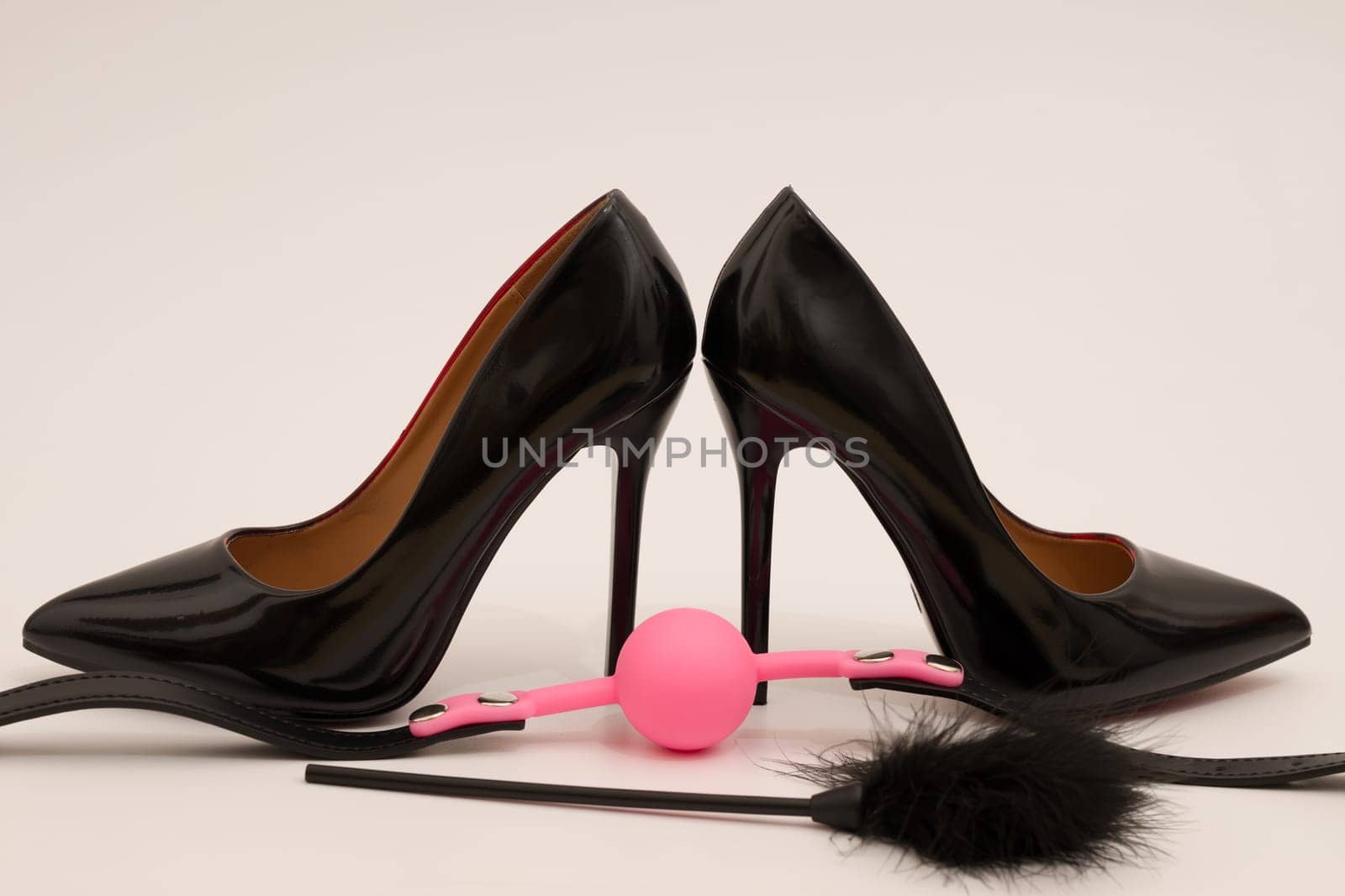 high heel fetish shoes feathered and ball gag fetish equipment isolated
