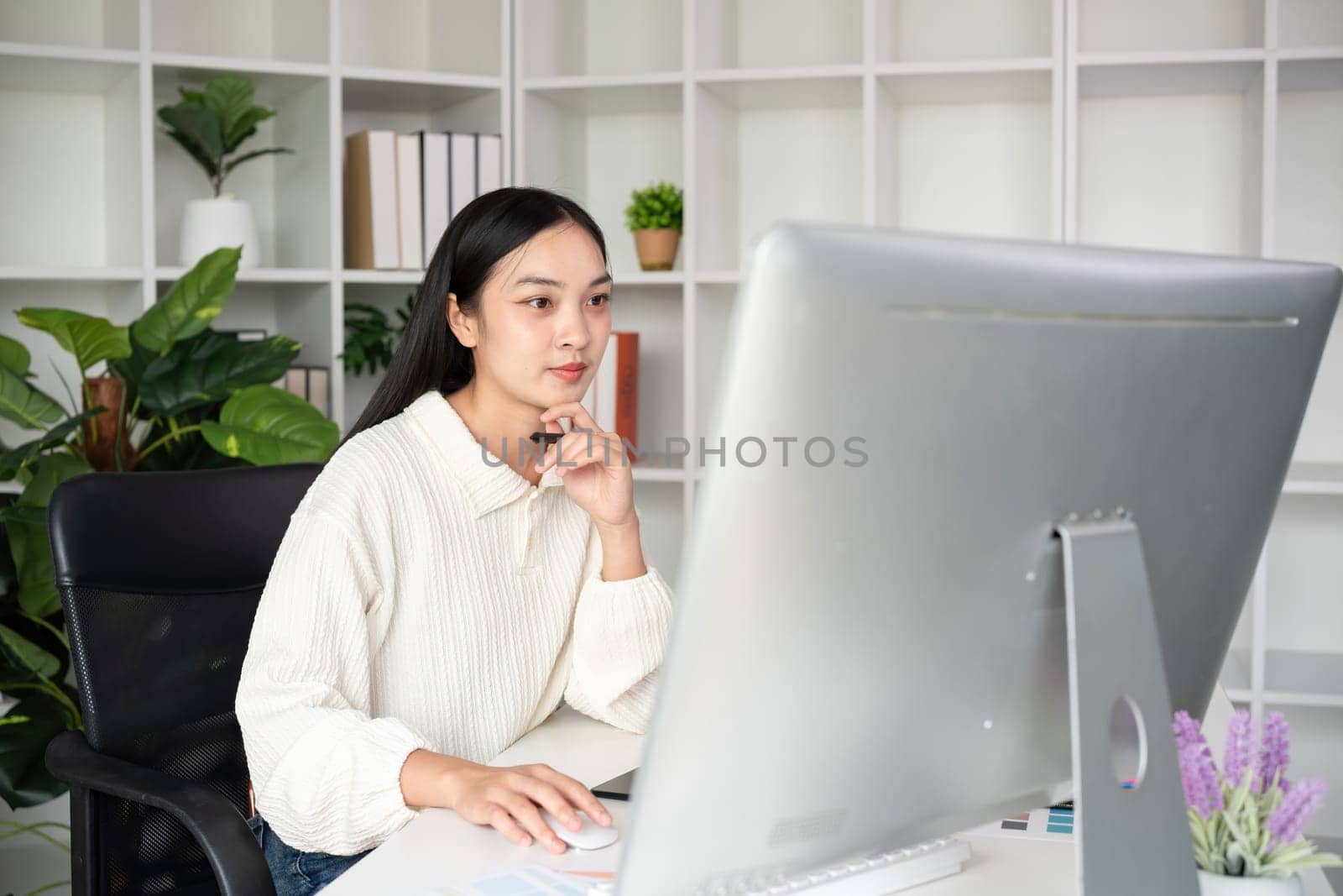 Beautiful business woman with determination Working on computer in home office.