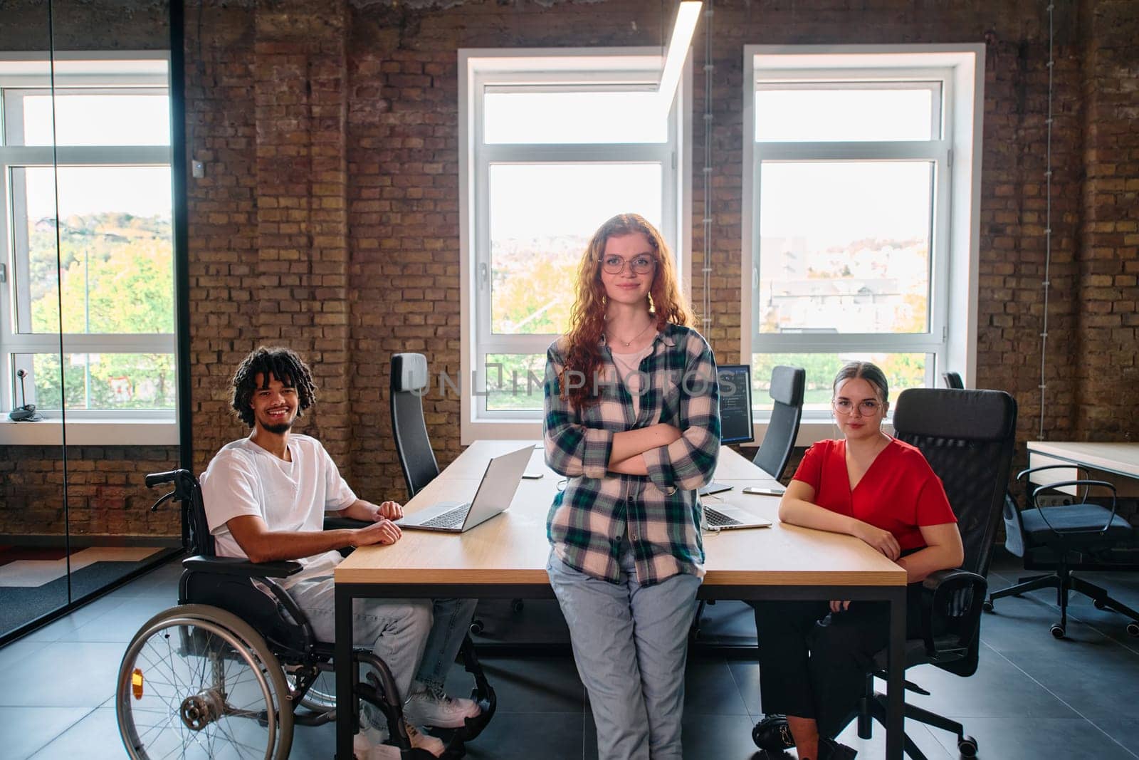 A diverse group of business professionals collaborates in a modern startup coworking center, utilizing a mix of paper-based and technological tools such as mobile phones and computers by dotshock