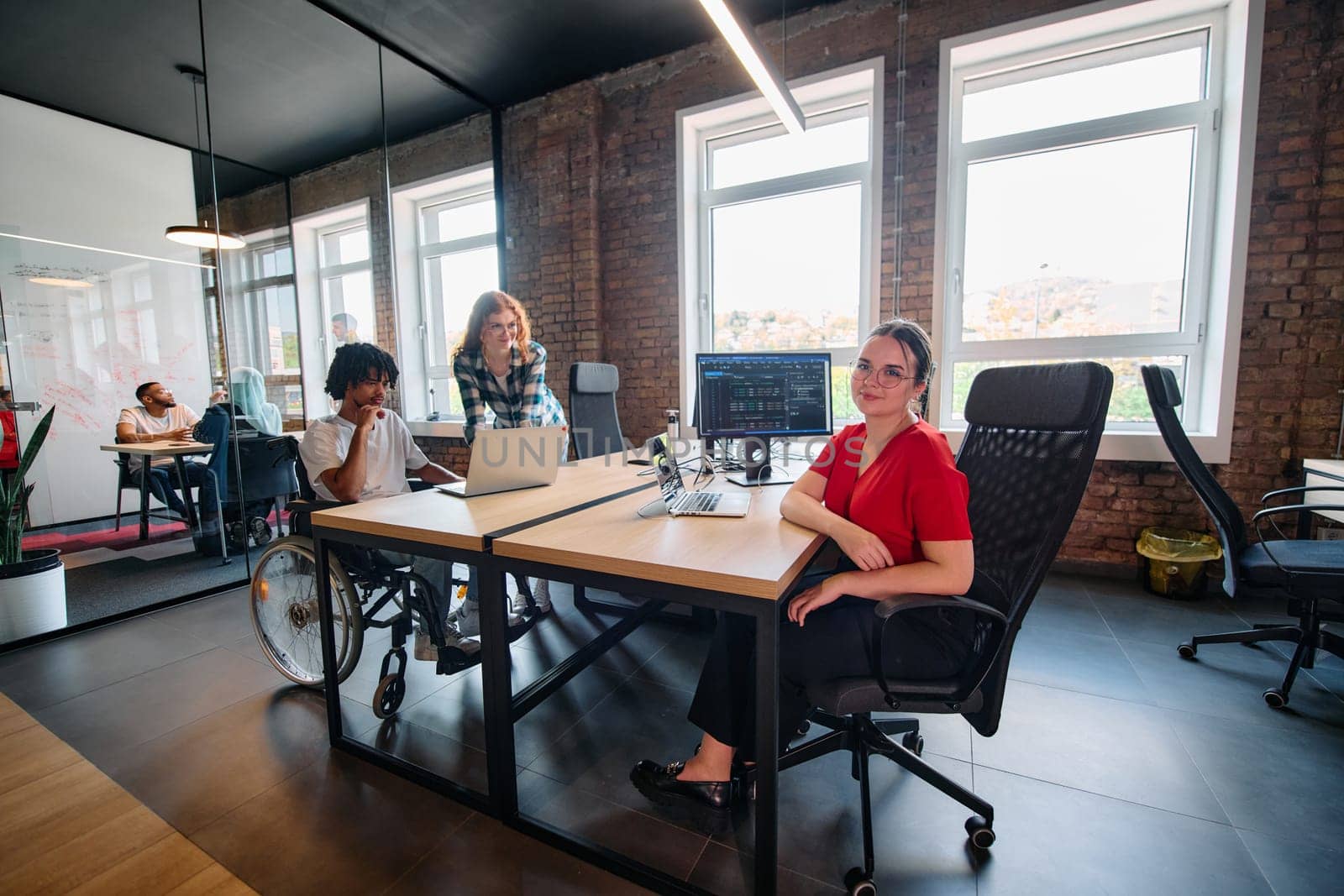 A diverse group of business professionals collaborates in a modern startup coworking center, utilizing a mix of paper-based and technological tools such as mobile phones and computers by dotshock