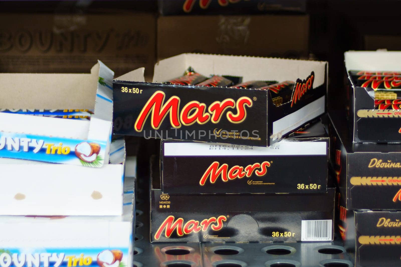 Tyumen, Russia-March 02, 2024: Mars chocolate bars are neatly arranged among various other candy products on a retail shelf.