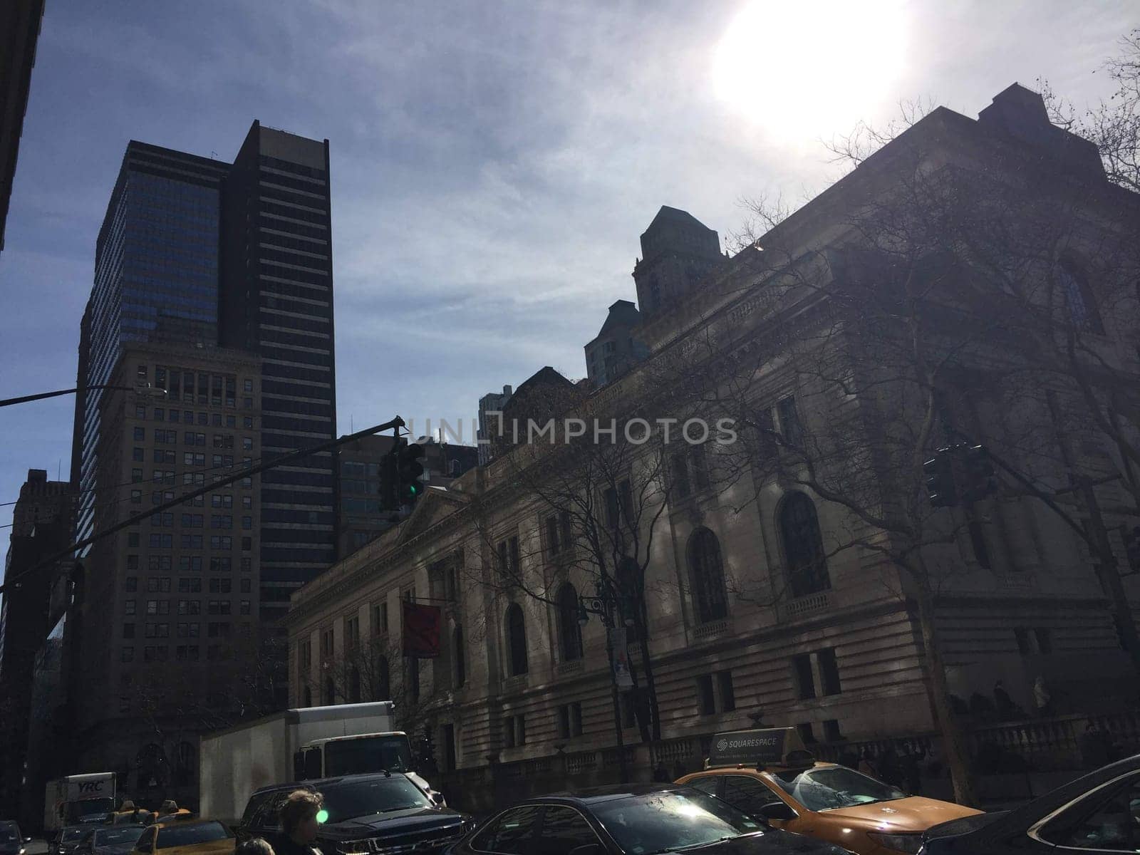 Busy new york city with many cars and taxies, van, buildings skyscraper in winter sunny day. High quality photo