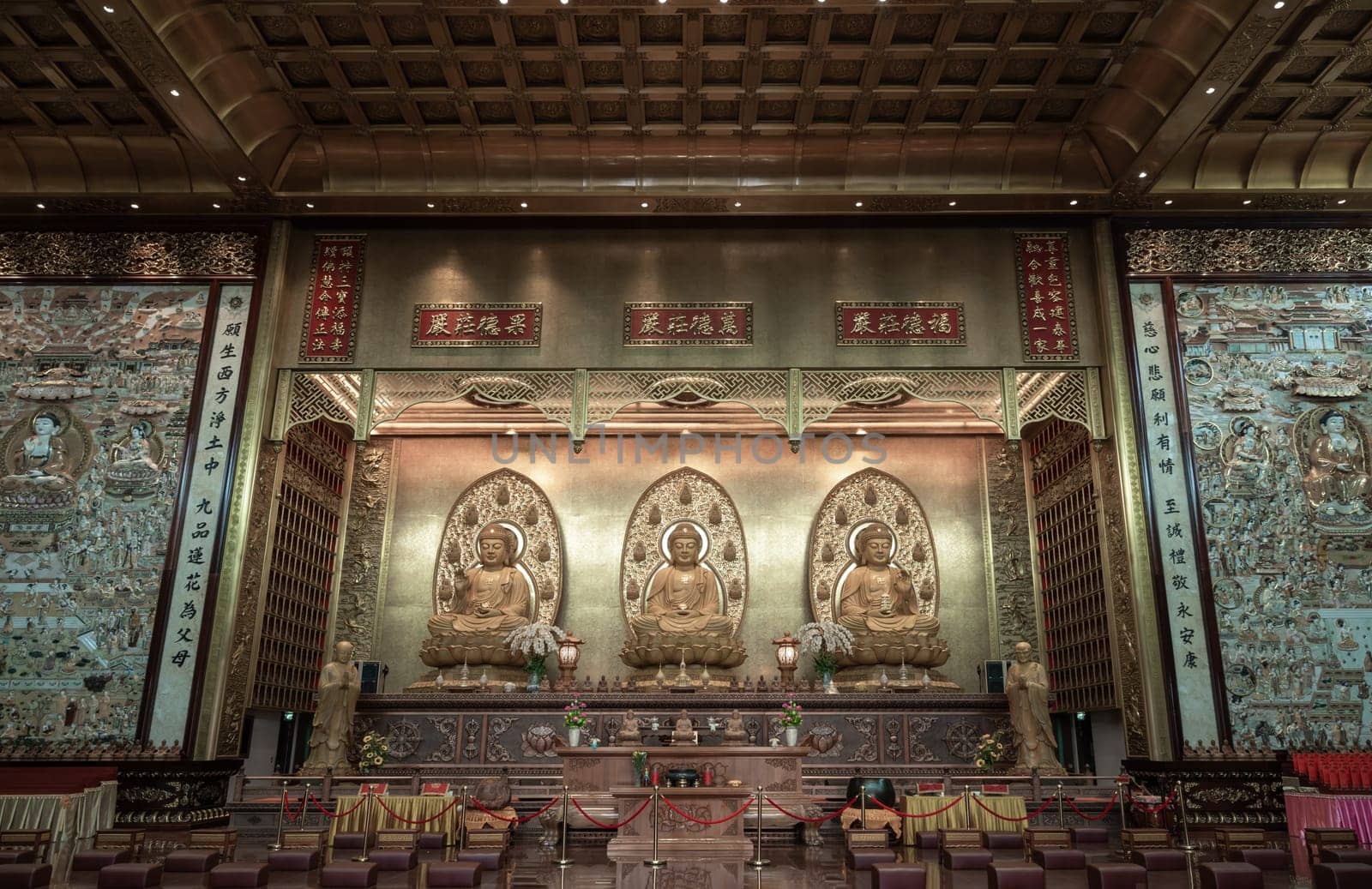 Bangkok, Thailand - Apr 11, 2024 - Three Buddha images inside Fo Guang Shan Thaihua Temple is famous place. Taiwanese temple style, The Institute of Buddhism, Space for text, Selective focus.