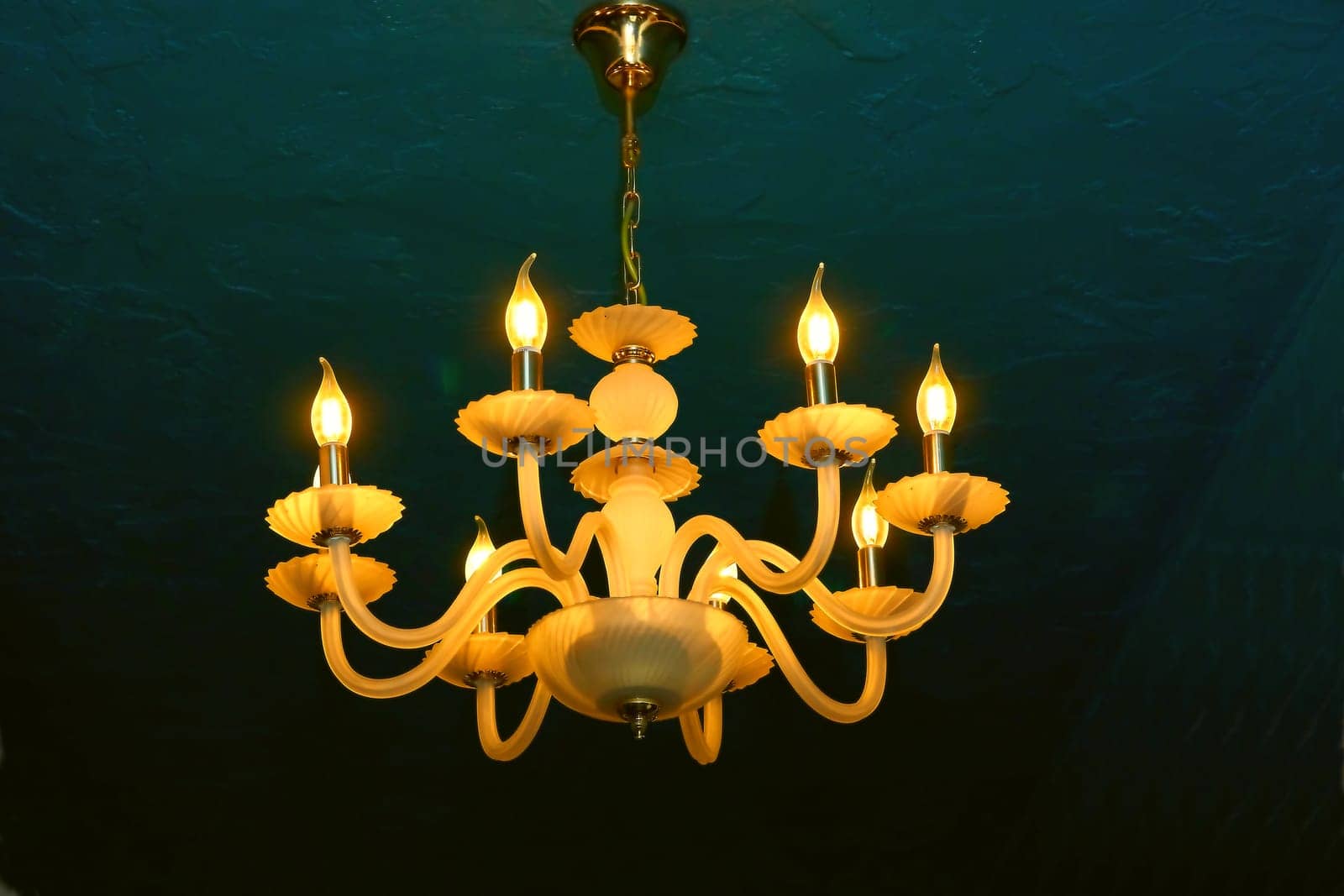 a decorative hanging light with branches for several light bulbs or candles