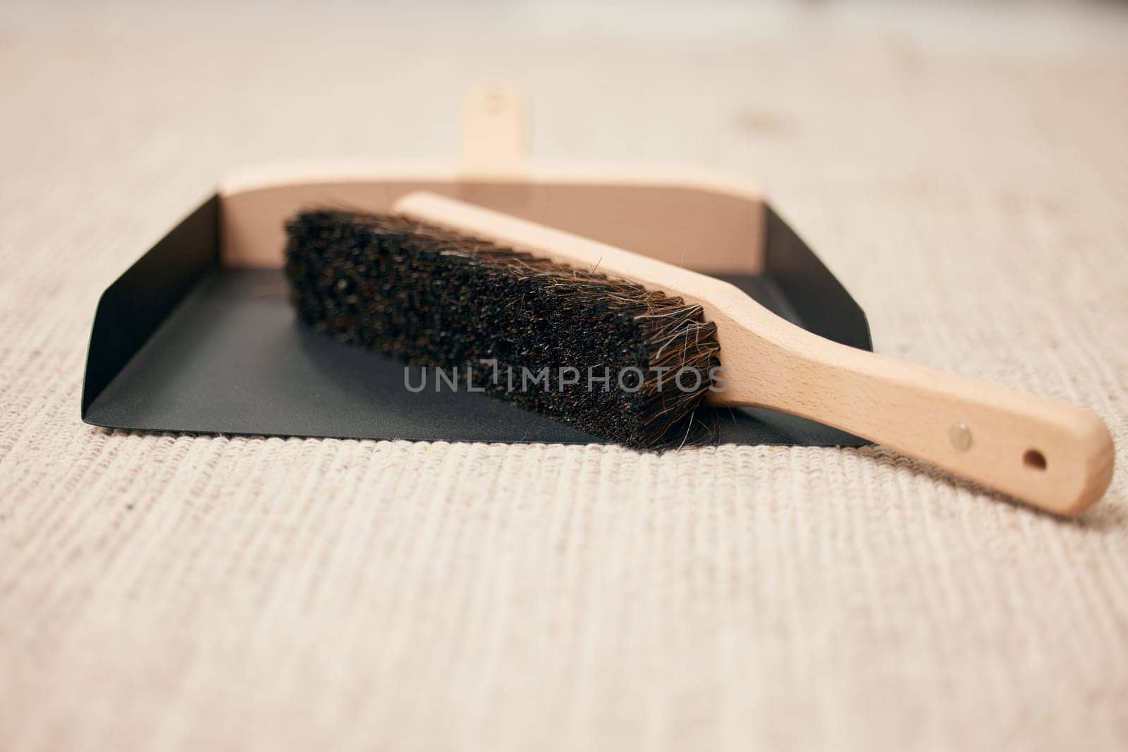 Scoop, brush and cleaning for home sweeping with healthy hygiene on carpet for chores, dirt or wellness. Dustpan, housekeeping and duties on floor in apartment for crumb mess, service or domestic by YuriArcurs