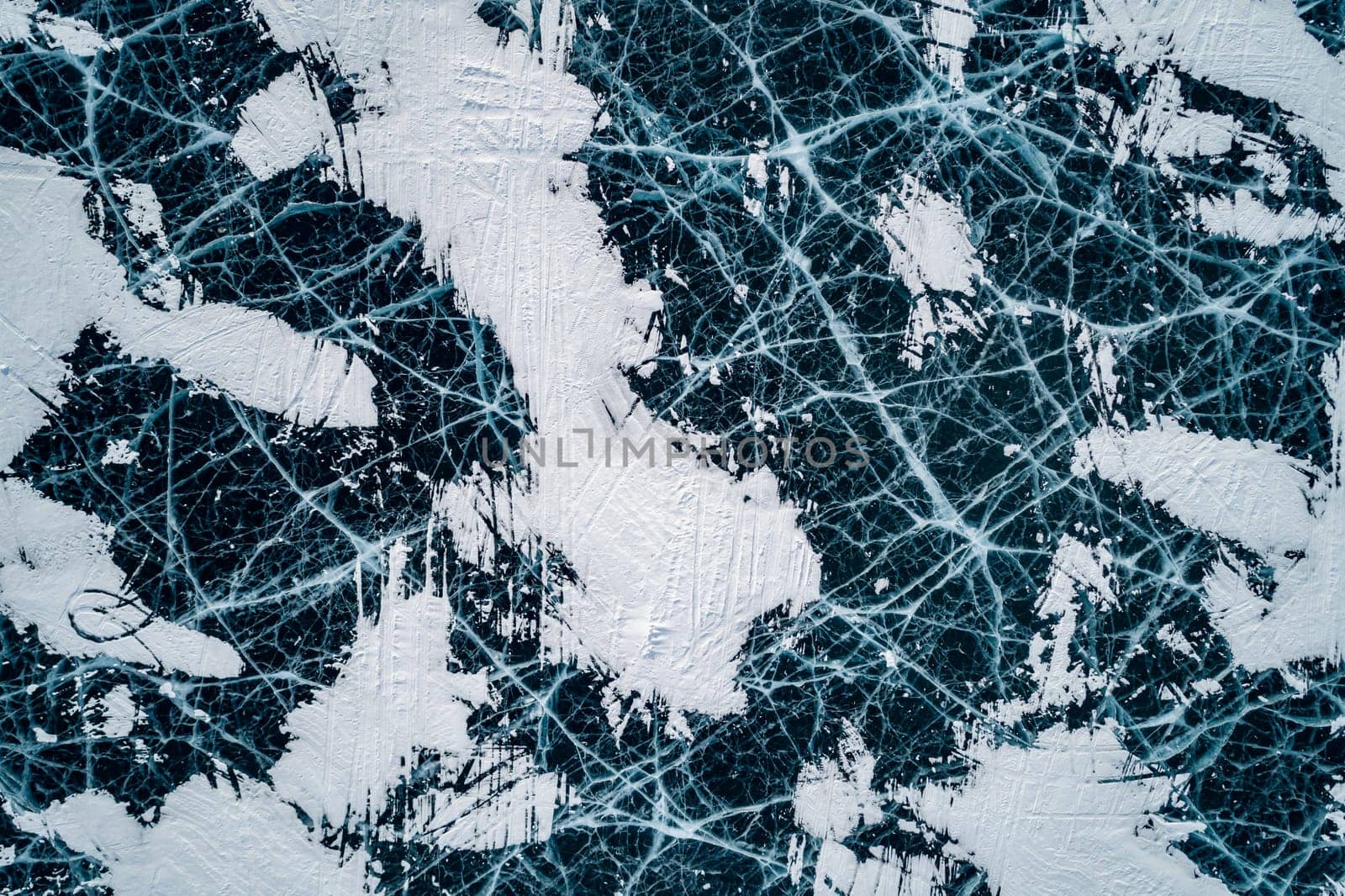 Aerial top down view on the blue cracked ice of the lake Baikal. Winter landscape, frozen lake. Ice kingdom. by Busker