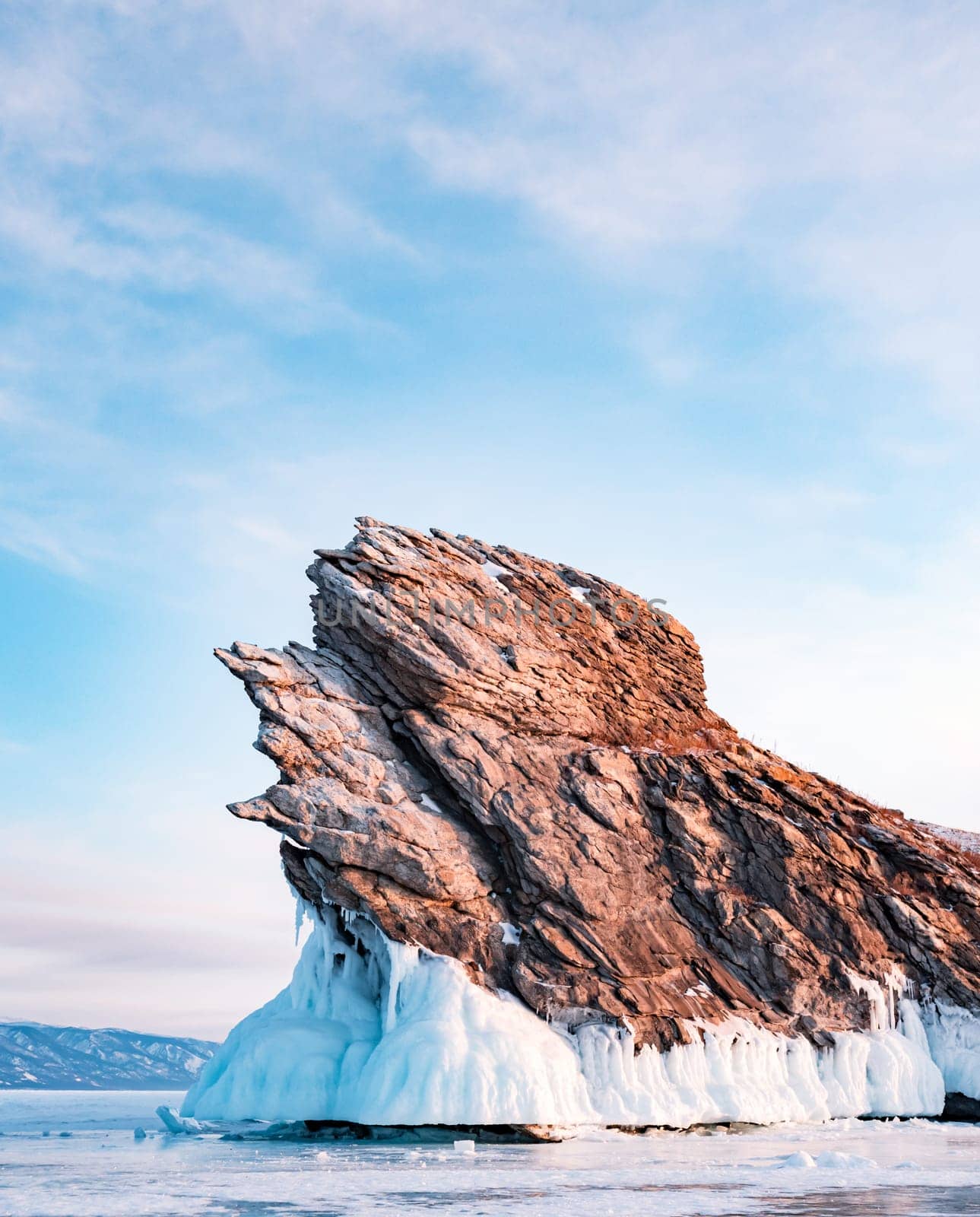 Ogoy island on winter Baikal lake. Winter scenery of Dragon Tail Rock on Ogoy island during sunrise at Lake Baikal.