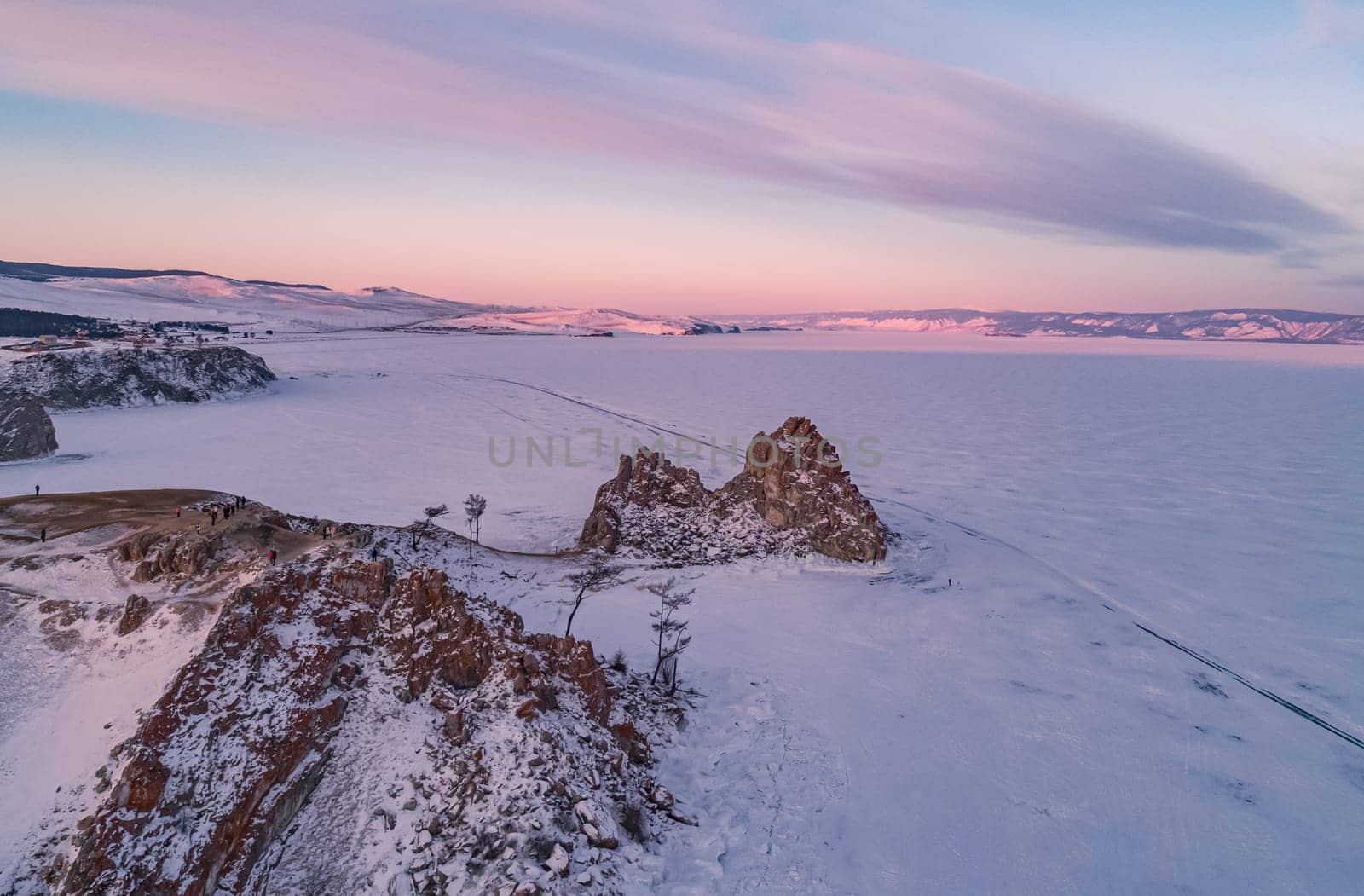 Aerial shot of a Shamanka rock on Olkhon island at sunset. Winter landscape. Popular touristic destination. Natural landmark. Panoramic view by Busker