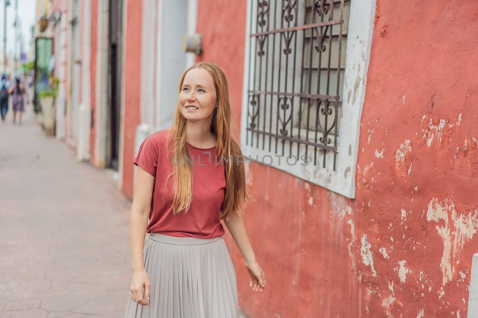 Woman tourist explores the vibrant streets of Valladolid, Mexico, immersing herself in the rich culture and colorful architecture of this charming colonial town by galitskaya