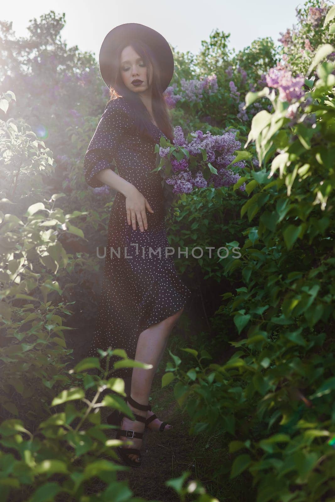 A fashionable girl with dark hair, a spring portrait in lilac tones in summer. Bright professional makeup. by Annu1tochka